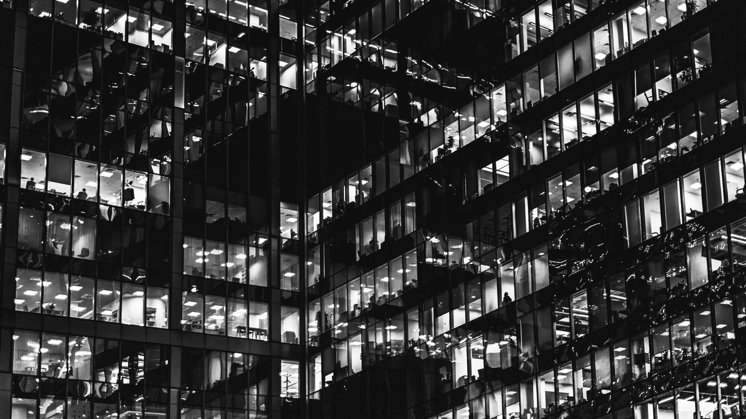 Office towers at night, a grid of lit windows
